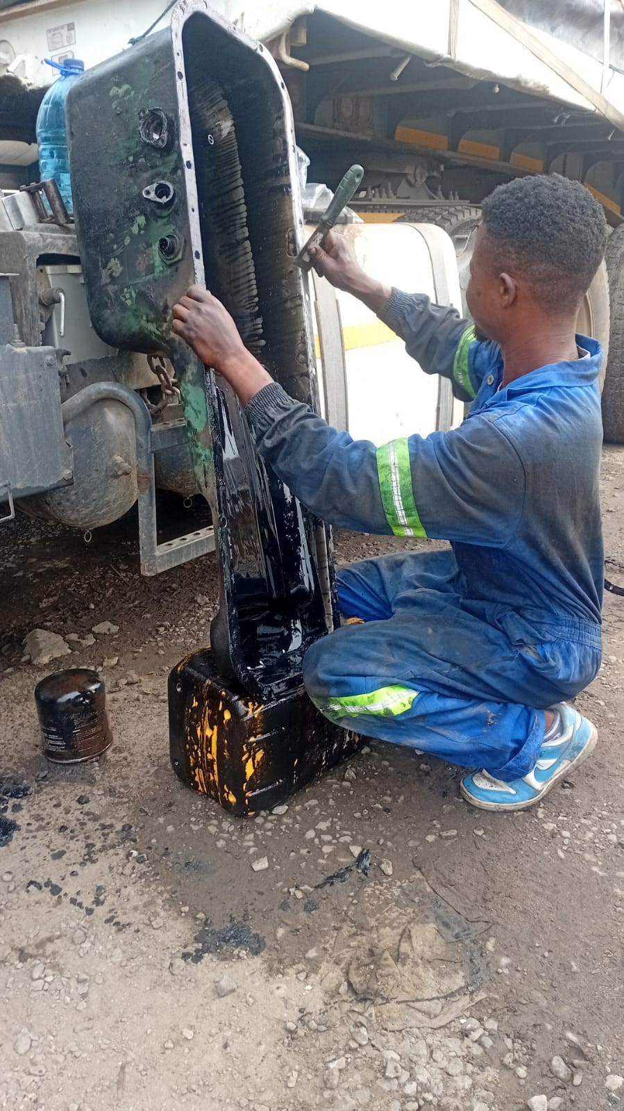 Mechanic servicing an oil sump